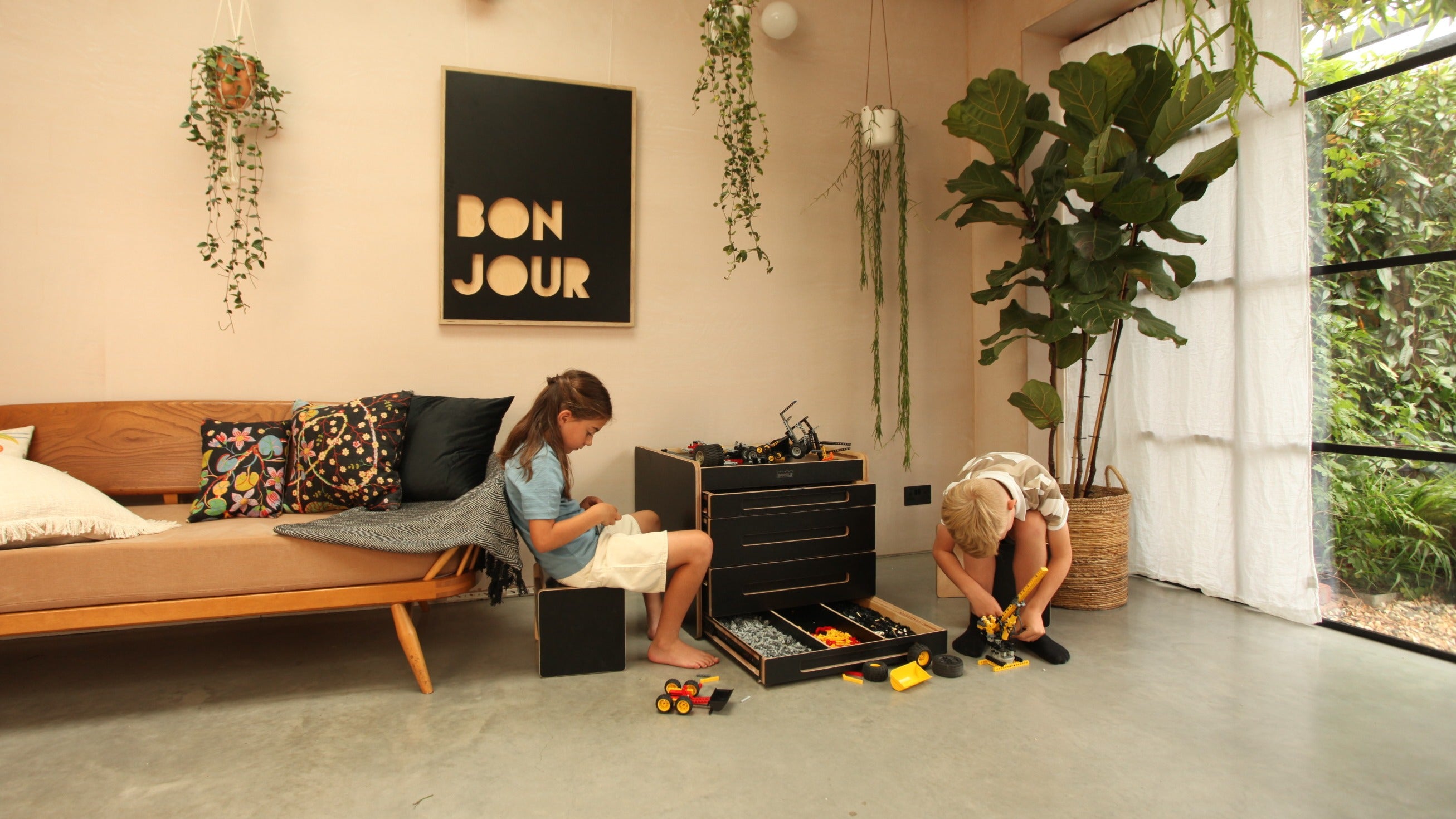 Black Brickle Bach in the family room with children playing LEGO